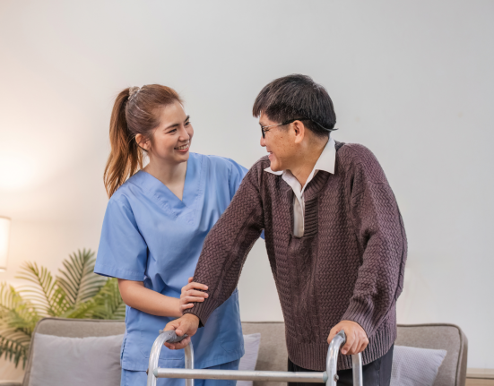 young asian female nurse care giver helping asian senior old man with mobility walker in living area of nursing home senior daycare center.